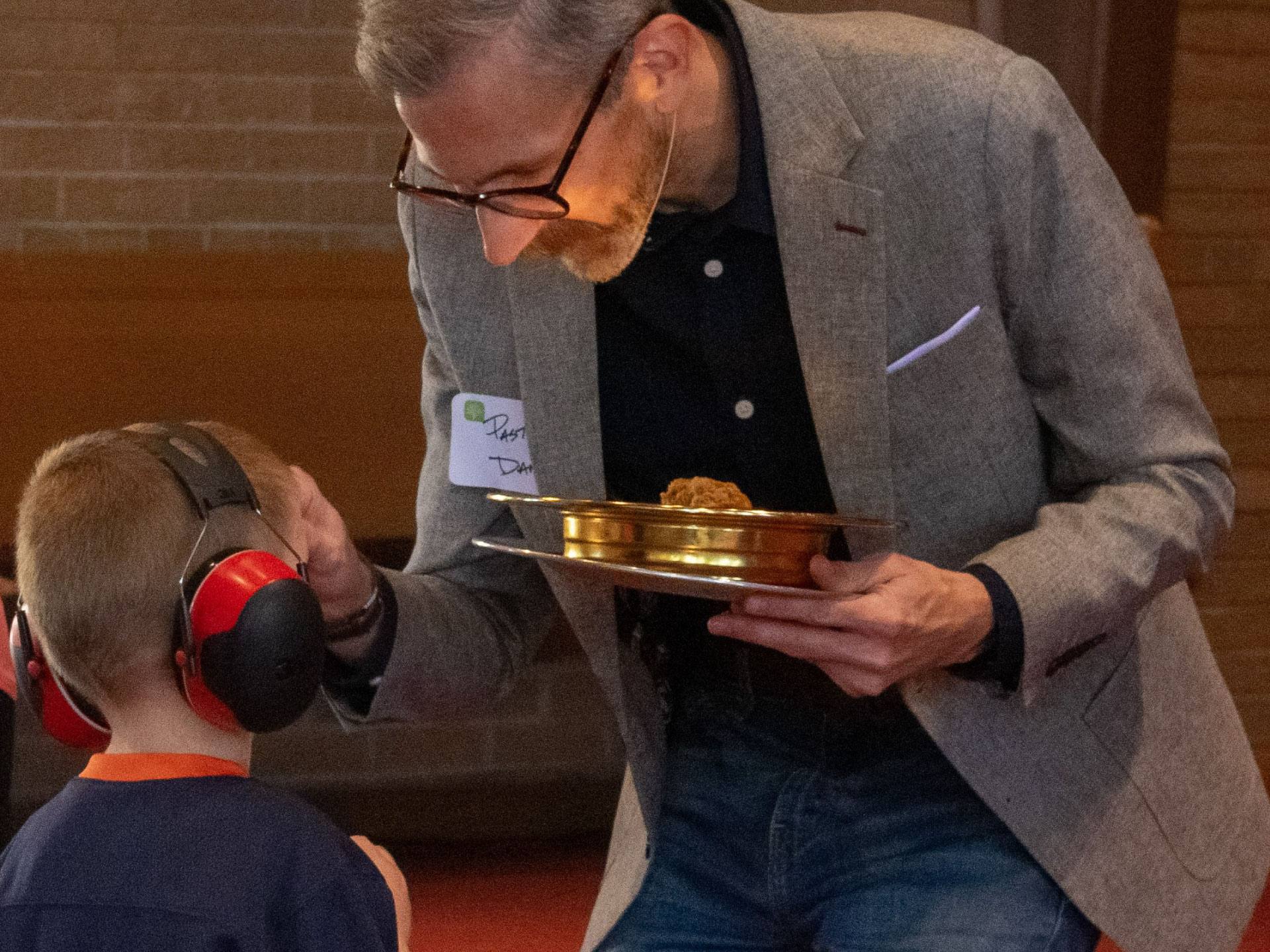 Pastor Dan serving communion to a child