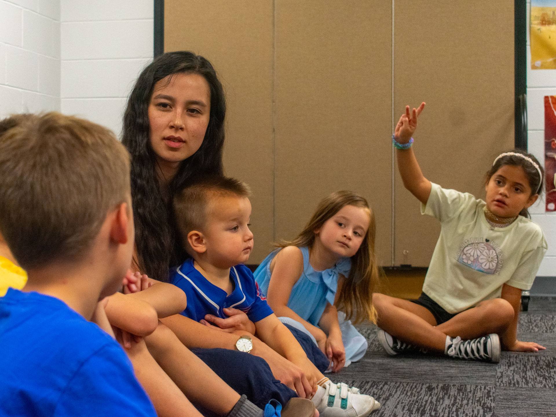 Children sitting together with a teacher at Redeemer